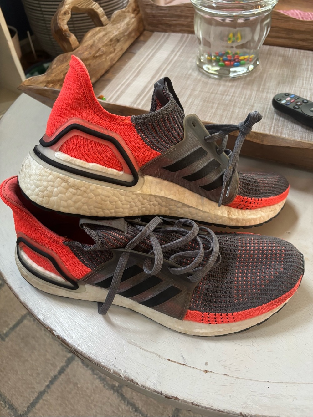 Adidas Ultraboost 19 sneakers in the "Hi Res Coral" colorway.